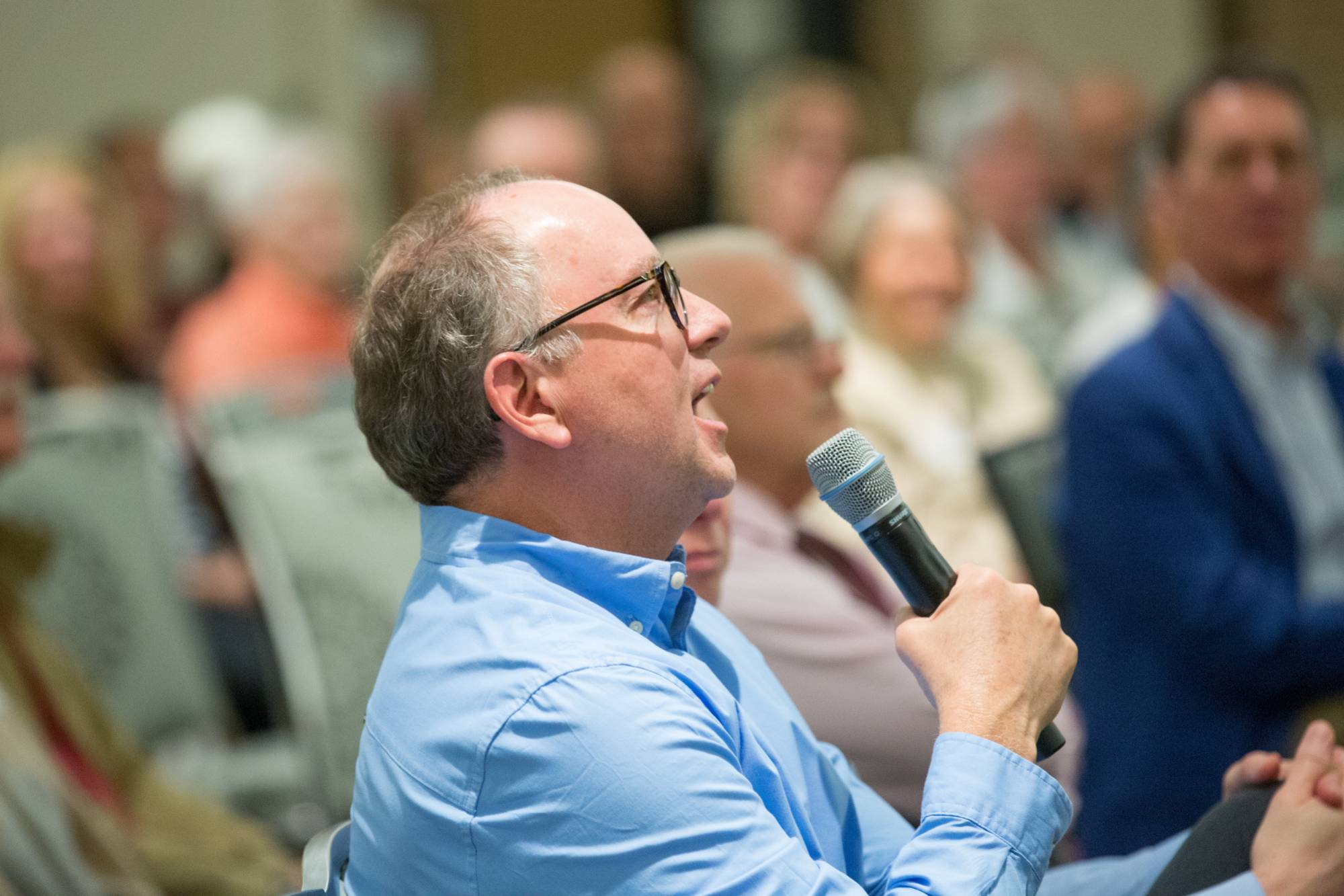 Man asking question through a microphone
